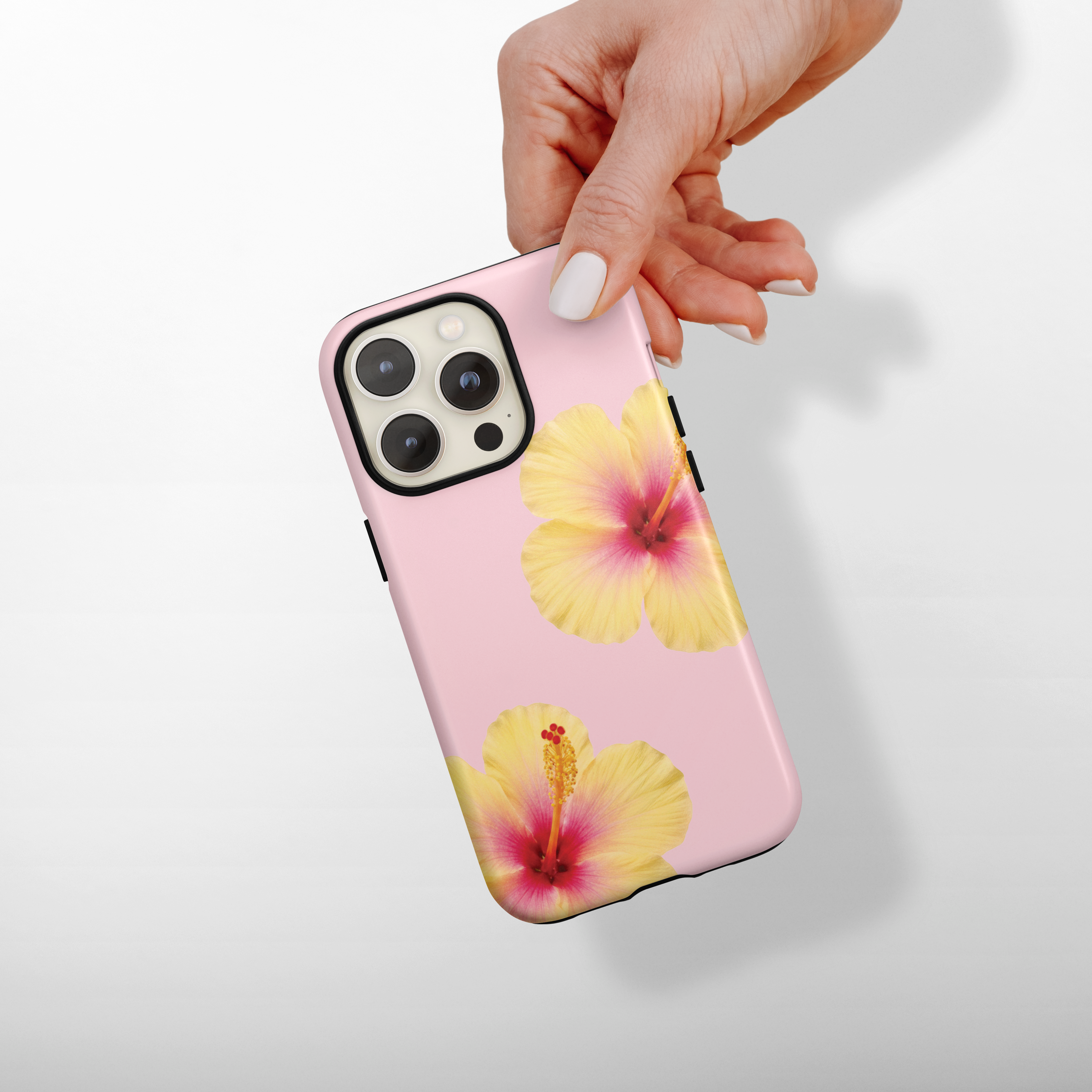 Phone case with floral design held by a hand on a light gray background