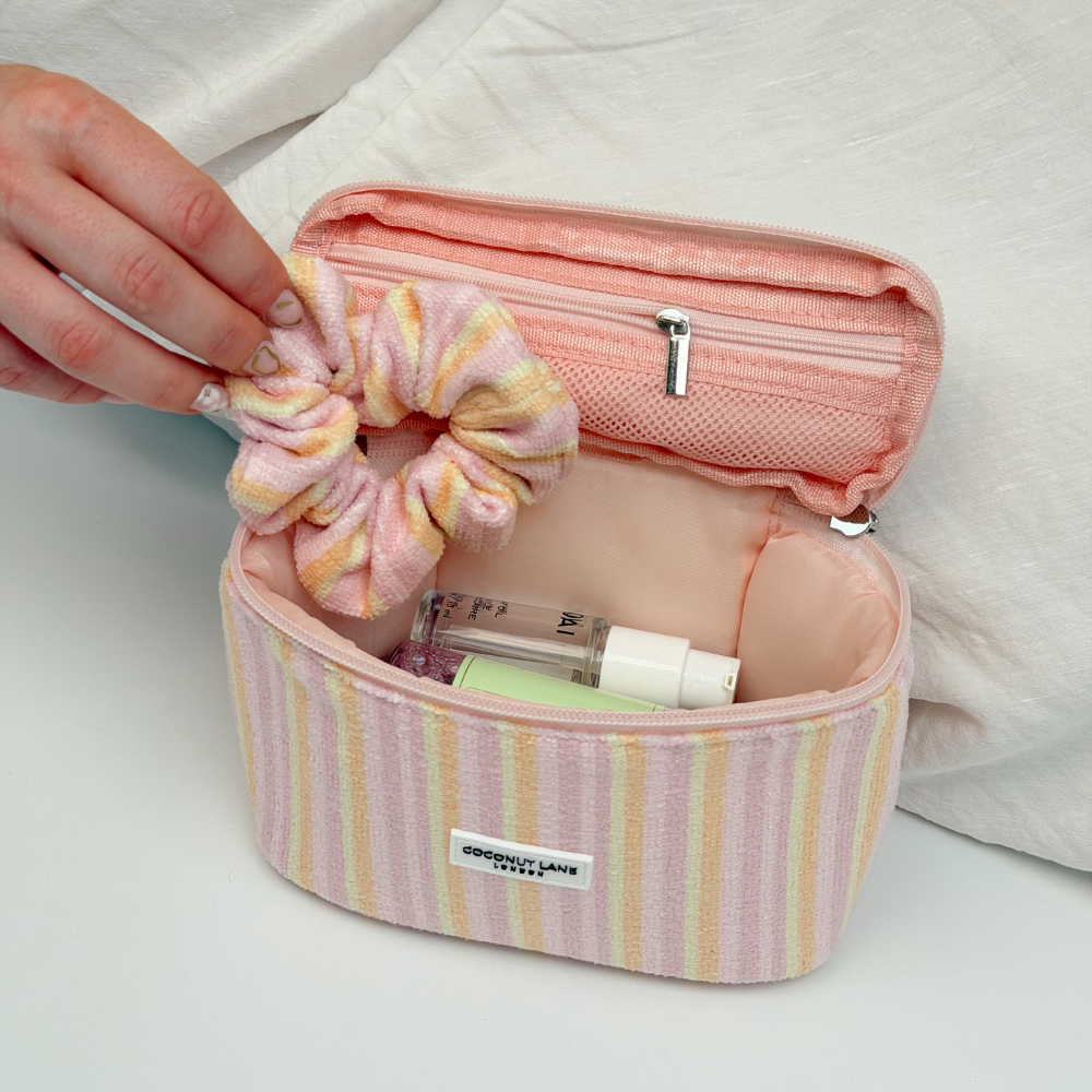 Girl putting scrunchie into mini vanity case pastel stripes