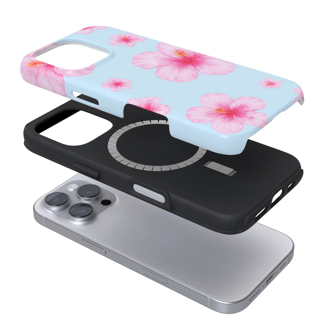 An iPhone with a two-part case: a black inner layer and a blue outer layer with pink hibiscus flowers, both shown separately above the phone in an exploded view.