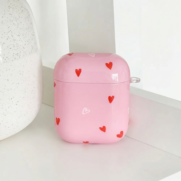 Pink AirPods Case with red and white heart design. 