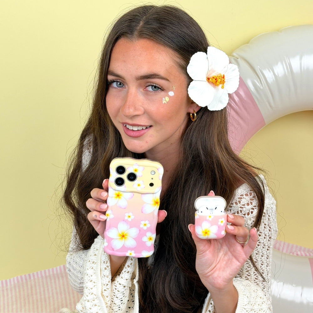 Woman holding Wavy Phone Case and Airpods Case with floral designs against a yellow background