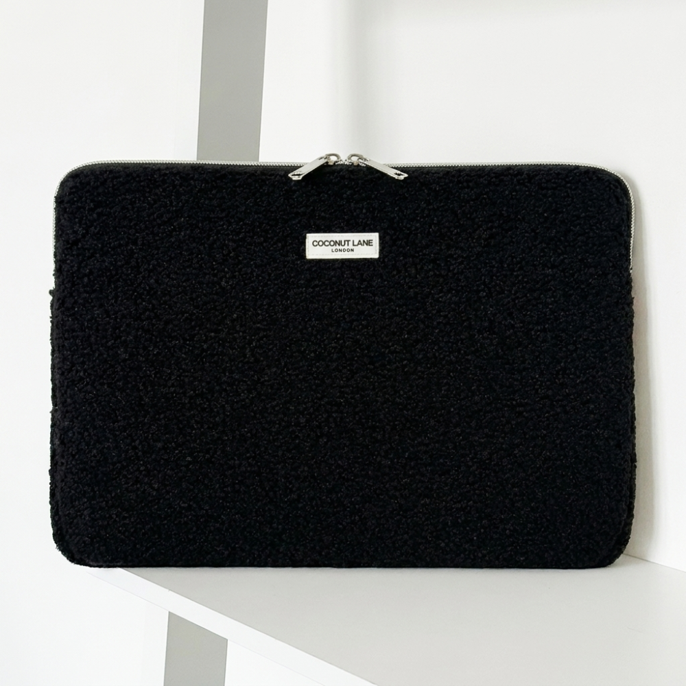Teddy black boucle textured Laptop Sleeve with zip closure and Coconut Lane logo. 