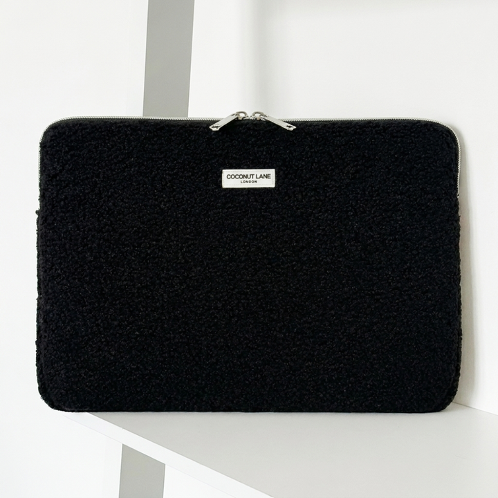 Teddy black boucle textured Laptop Sleeve with zip closure and Coconut Lane logo. 