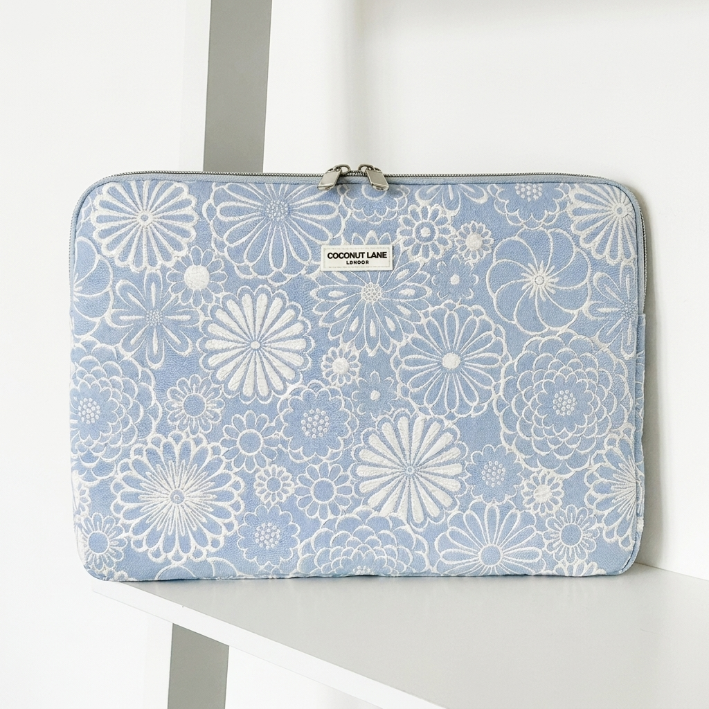 Blue and white flower design Laptop Sleeve with zip closure and Coconut Lane logo. 