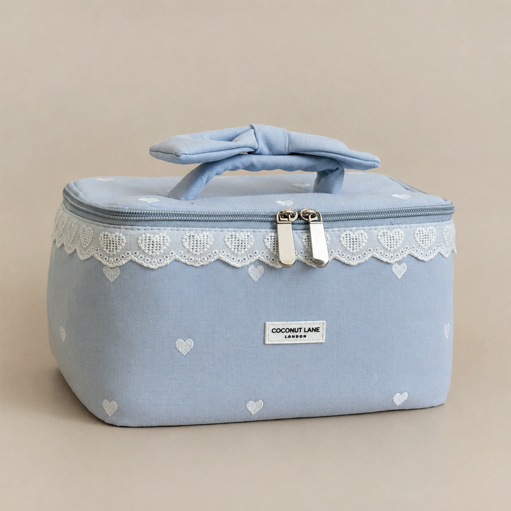 Light blue Vanity Bag with embroidered hearts. Lace trim and handle with bow.