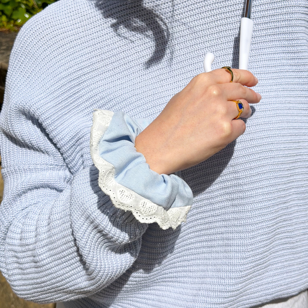 Close up image of Blue Hearts Lace Scrunchie on wrist