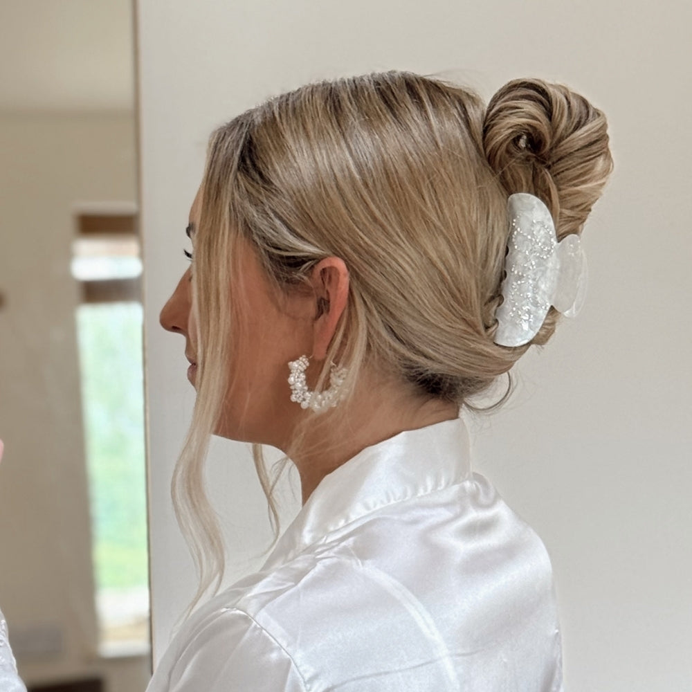 Woman with styled hair featuring a bride claw clip.