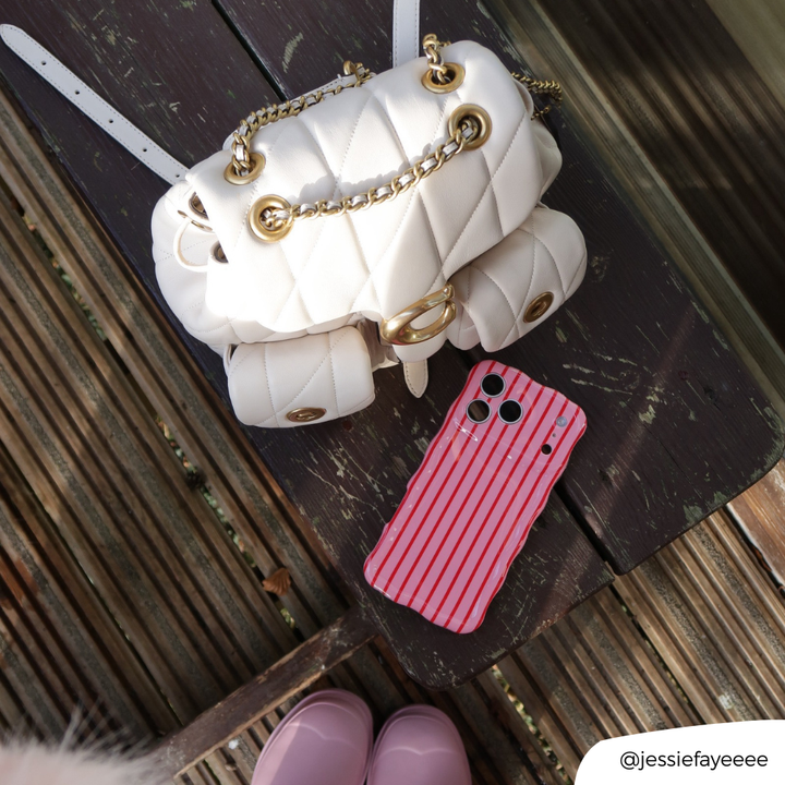 Wavy Cherry Stripe phone case next to white bag