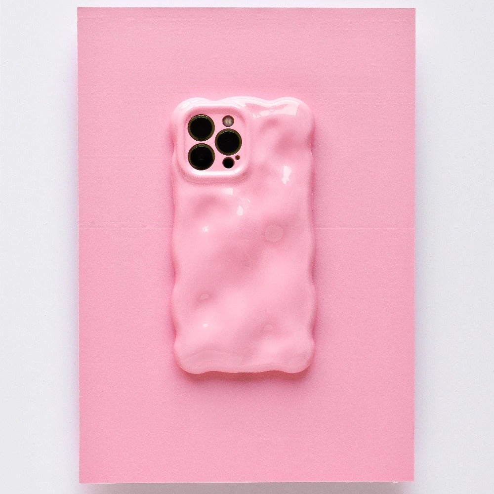 A chic and colorful upgrade, this smartphone features the Coconut Lane 3D Gummy Phone Case - Pink, showcasing a textured pink design with a melting effect set against a matching pink background. The unique, irregular surface enhances the phone's triple camera setup visible at the top left corner.