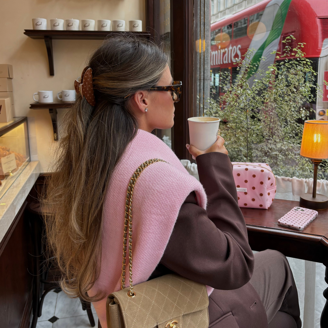 Woman with long wavy brunette hair. In her hair is the Dot Society Chocolate Brown polka dot claw clip.