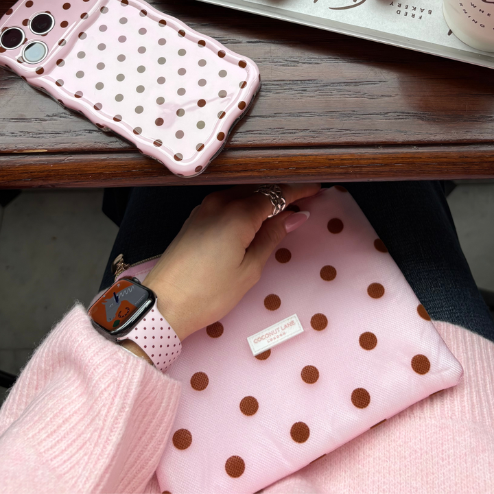 Dot Society Pink and brown Apple watch strap. Baby pink watch strap with dainty brown polka dot design. Alongside the matching dot society everything pouch and wavy phone case.