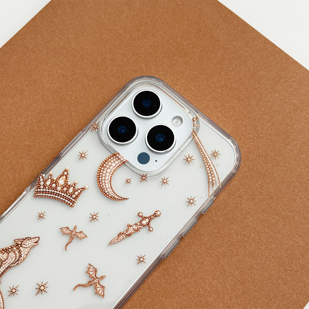 Close-up of Fantasy Girl Clear Phone Case showing intricate rose gold celestial details, including a crown, crescent moon, dagger, dragons and stars, with clear edges and triple camera cutouts.