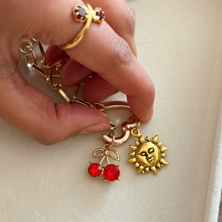 Heart clasp being opened to add charms onto phone strap chain