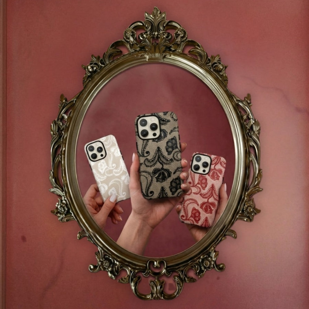 A reflection of three lace tough phone cases held up in front of a decorative mirror on a red wall