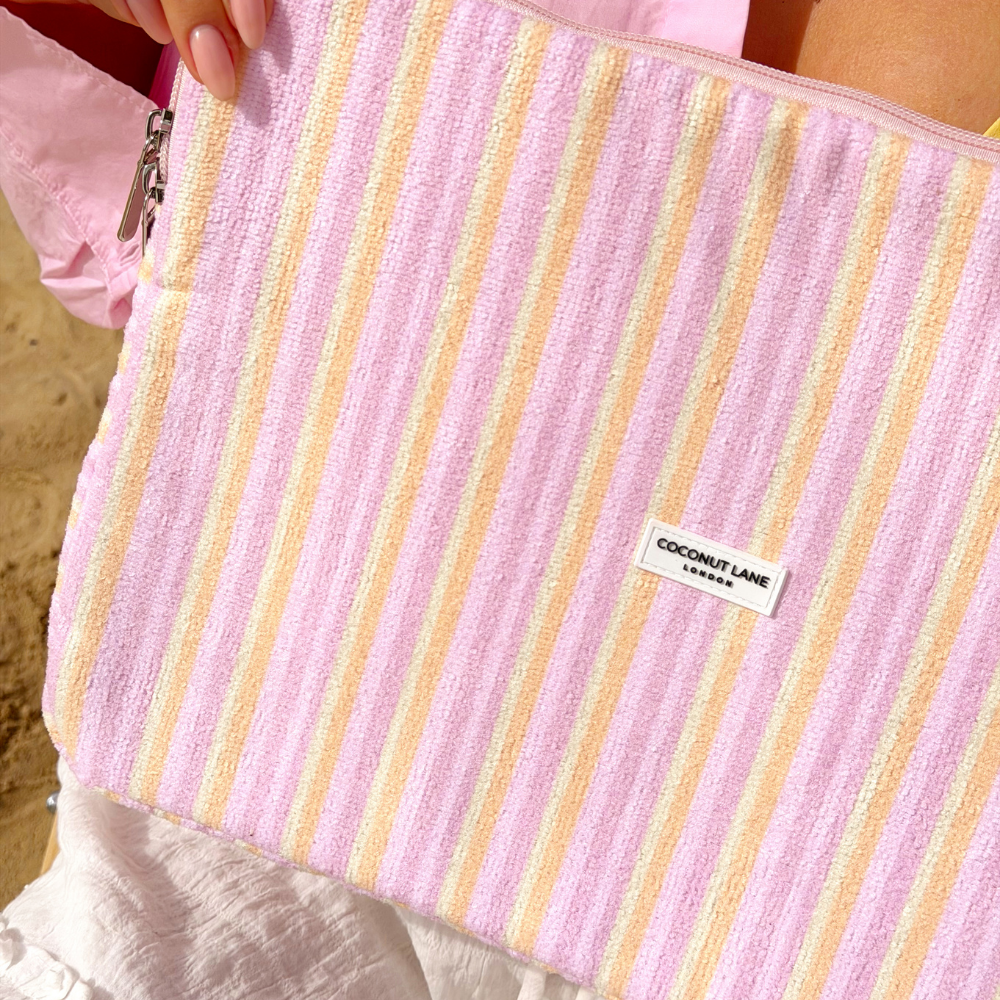 Close up of the towel laptop sleeve in pastel stripes - yellow, pink, purple