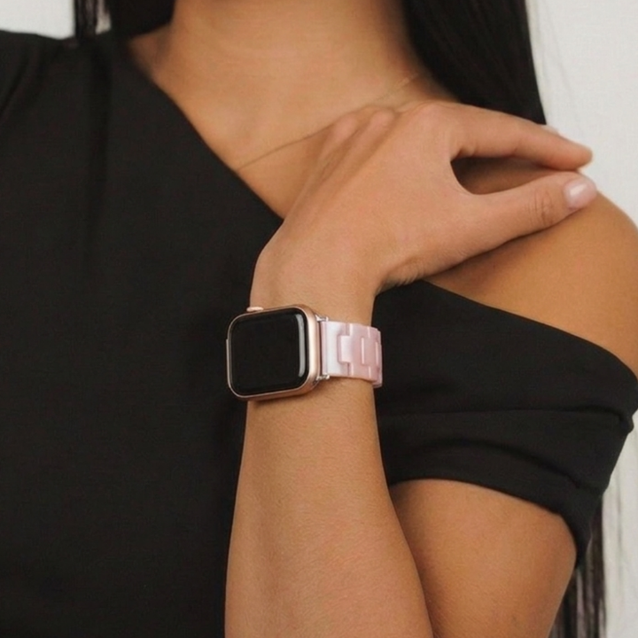 Girl wearing luxe pink watch strap on wrist in black top studio shoot