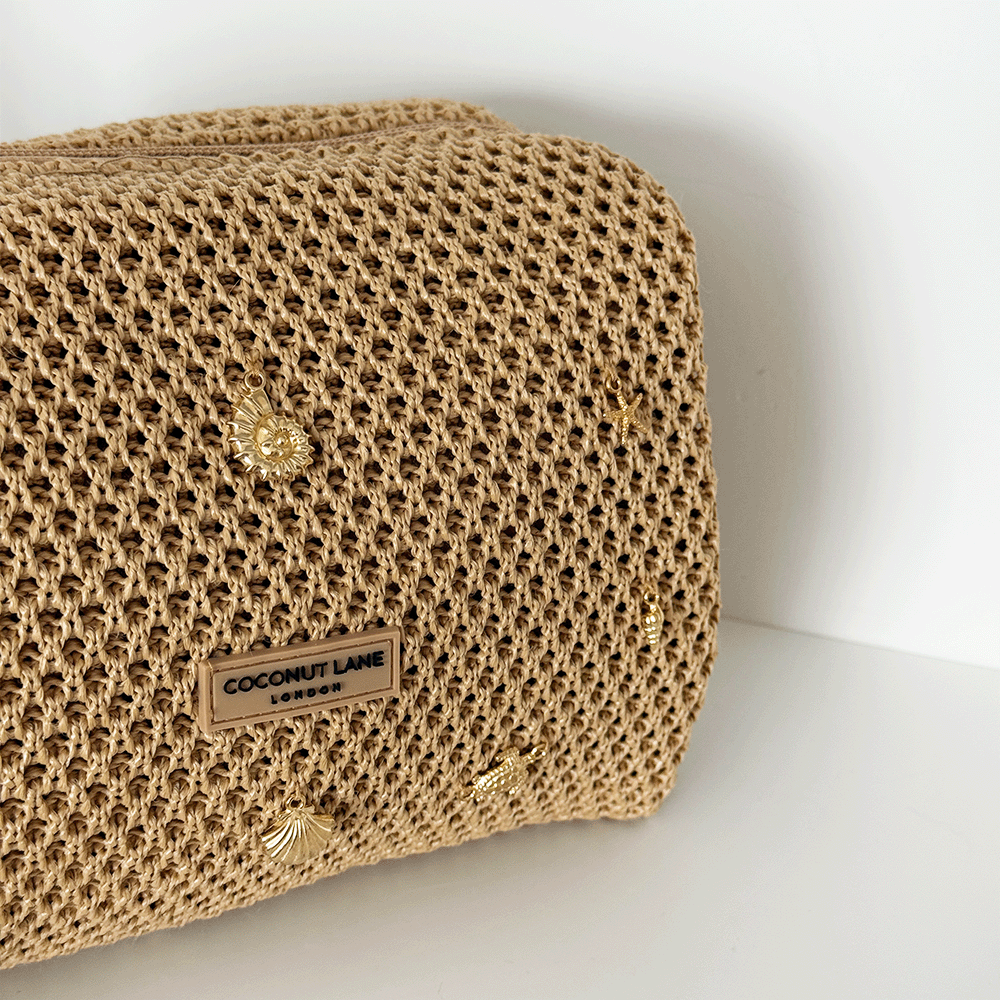 Beige woven bag with gold embellishments.