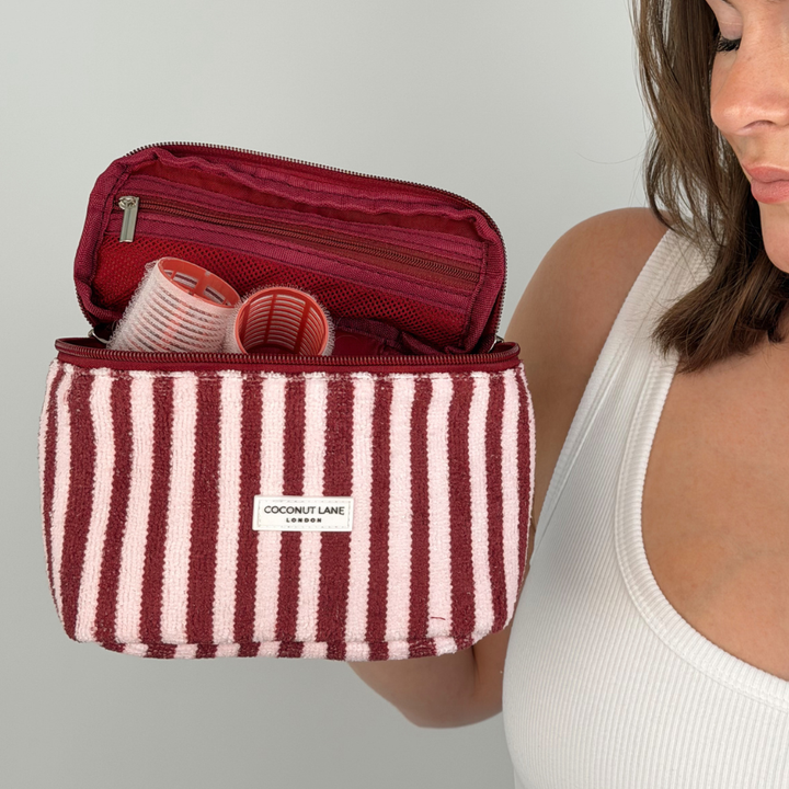 Girl holding makeup bag with rollers inside
