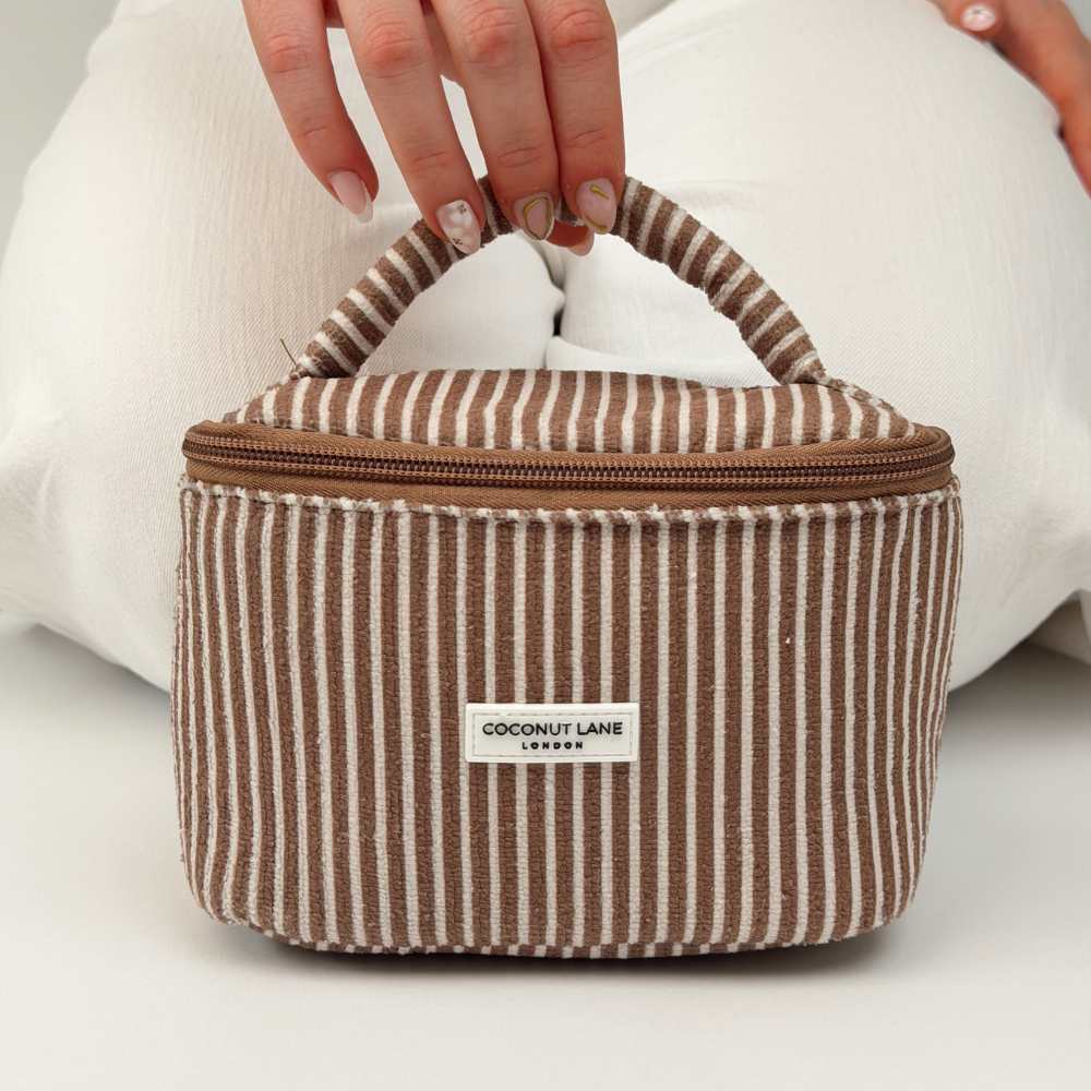 Close up of the mini towel travel vanity case in chestnut stripes
