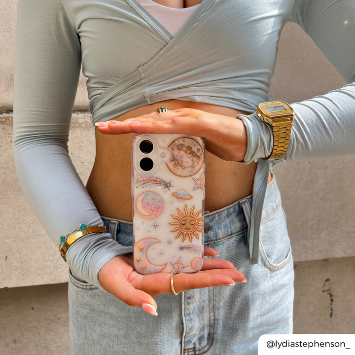 Girl holding Opal Celestial Phone Case in matching blue outfit