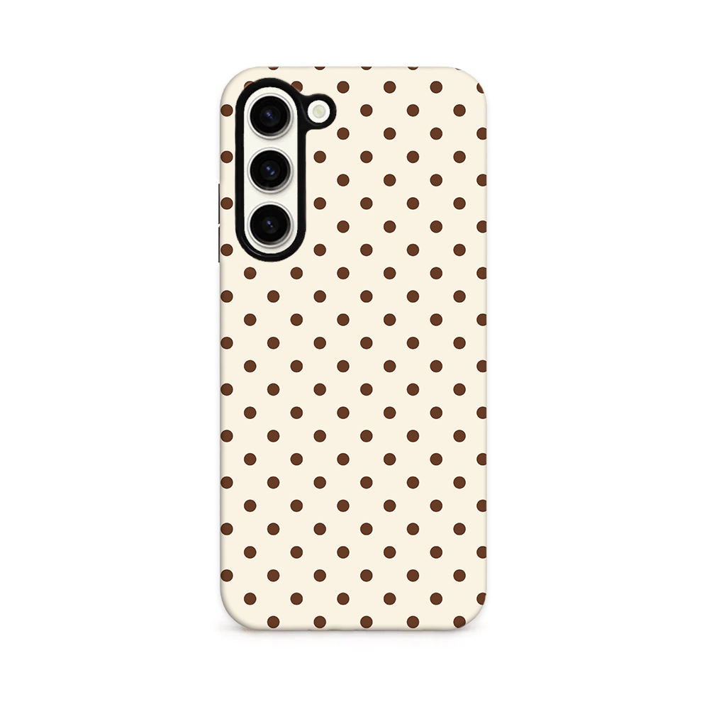 Chocolate brown spots on a cream background.