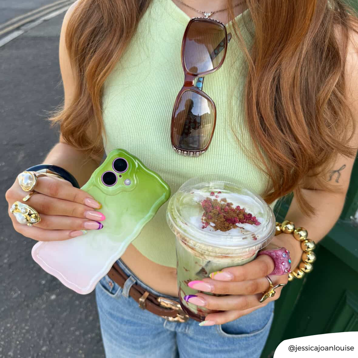Girl holding strawberry matcha to match her wavy phone case strawberry matcha